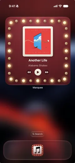Marquee home screen widget on iPhone with golden theater bulbs around Apple Music album art